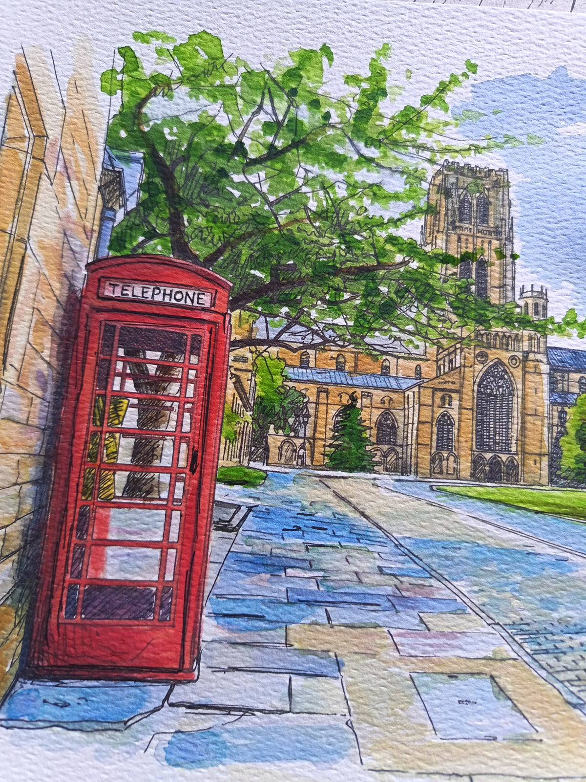 Watercolor and ink-style artwork depicting a red telephone booth beside a stone wall, with a tree, cobblestone path, and a large cathedral in the background.